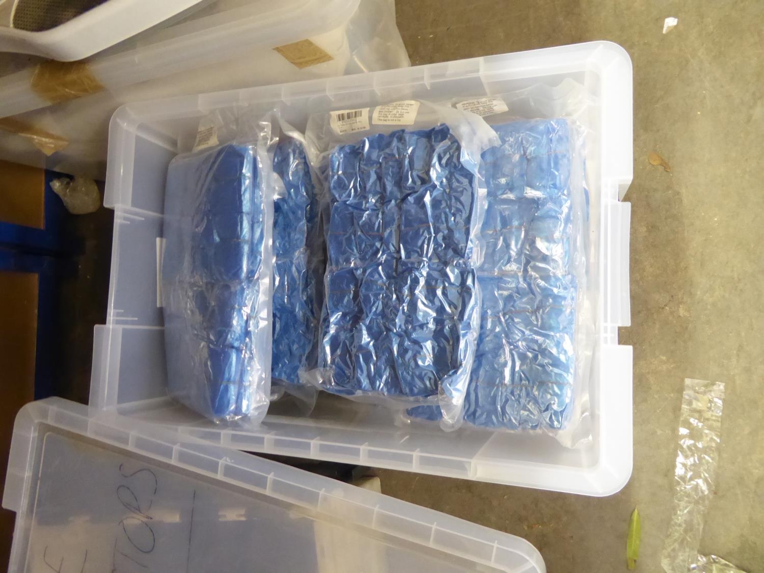 PLASTIC CRATE CONTAINING PACKETS OF SHOE COVERS/PROTECTORS (QUANTITY)