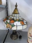 TIFFANY STYLE METAL TABLE LAMP WITH LEADED AND STAINED GLASS DOMED SHADE