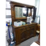 AN ARTS AND CRAFTS OAK MIRROR BACK SIDEBOARD , THE BASE HAVING TWO DRAWERS ABOVE TWO CUPBOARDS, (