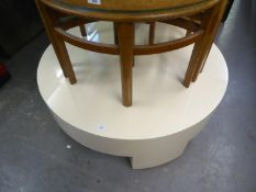 A CREAM PLASTIC COVERED LARGE CIRCULAR COFFEE TABLE, DRUM SHAPED