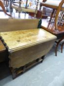 AN OAK DROP LEAF DINING TABLE WITH WAVY EDGE, RAISED ON SPIRAL SUPPORTS