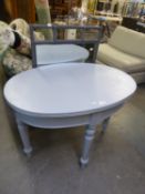 A GREY PAINTED BAMBOO FRAMED WALL MIRROR, AND A GREY PAINTED OVAL SIDE TABLE, RAISED ON TURNED