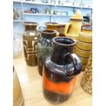 THREE WEST GERMAN STYLISH POTTERY CYLINDRICAL VASES, including one banded in orange and oatmeal, and