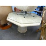 A GOOD QUALITY CULTURED MARBLE OCTAGONAL SHAPED DINING TABLE, HAVING GLASS PROTECTOR, RAISED ON AN
