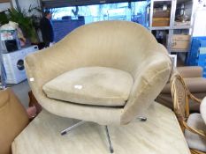 a 1960'S BUCKET ARMCHAIR, COVERED IN FAWN COLOURED FABRIC AND RAISED ON A FIVE SPUR CHROME BASE