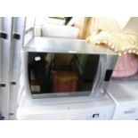 A CANDY CMC 300CS MICROWAVE OVEN IN SILVER COLOURED CASE