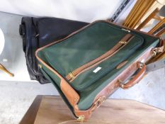 A GREEN CANVAS AND LEATHER MOUNTED SUITCASE, 22” WIDE AND A GENT’S BLACK LEATHER FOLD-OVER SUIT