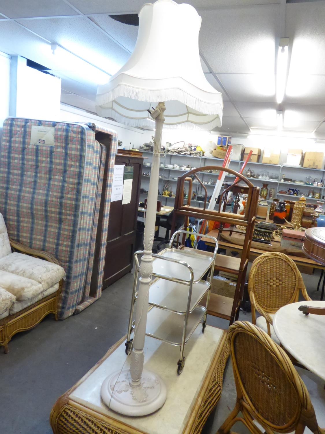 A WHITE PAINTED WOOD TURNED STANDARD LAMP WITH SILK SHADE AND A GILT THREE TIER TEA TROLLEY (2)