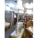 A WHITE PAINTED WOOD TURNED STANDARD LAMP WITH SILK SHADE AND A GILT THREE TIER TEA TROLLEY (2)