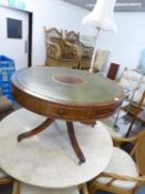 A LARGE LOW DRUM-TOP COFFEE TABLE WITH GREEN LEATHER INSET TOP, RAISED ON A QUARTETTE BASE (95cm