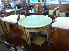 A CIRCULAR OCCASIONAL TABLE WITH GREEN LEATHER INSET TOP WITH FOUR NESTING QUARTER TABLES WITH