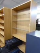 A PINE SEVEN TIER OPEN BOOKCASE WITH FOUR WOODEN TIERS AND THREE PLATE GLASS SHELVES