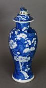 A late 19th Century Nanking blue and white porcelain baluster vase and domed cover with Kylin