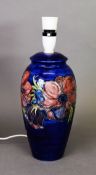 Moorcroft pottery tall ovular vase table lamp, with large red flowers on a royal blue ground,