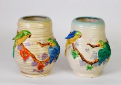 NEAR PAIR OF CLARICE CLIFF CERAMIC VASES, with moulded budgerigar and vine decoration, both