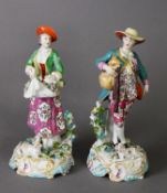 A PAIR OF CHELSEA STYLE FIGURE GROUPS, one as a lady gathering blooms in her pinafore, the other a