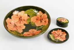 THREE PIECES OF WALTER MOORCROFT HIBISCUS PATTERN TUBE LINED POTTERY ON GREEN GROUNDS, comprising: