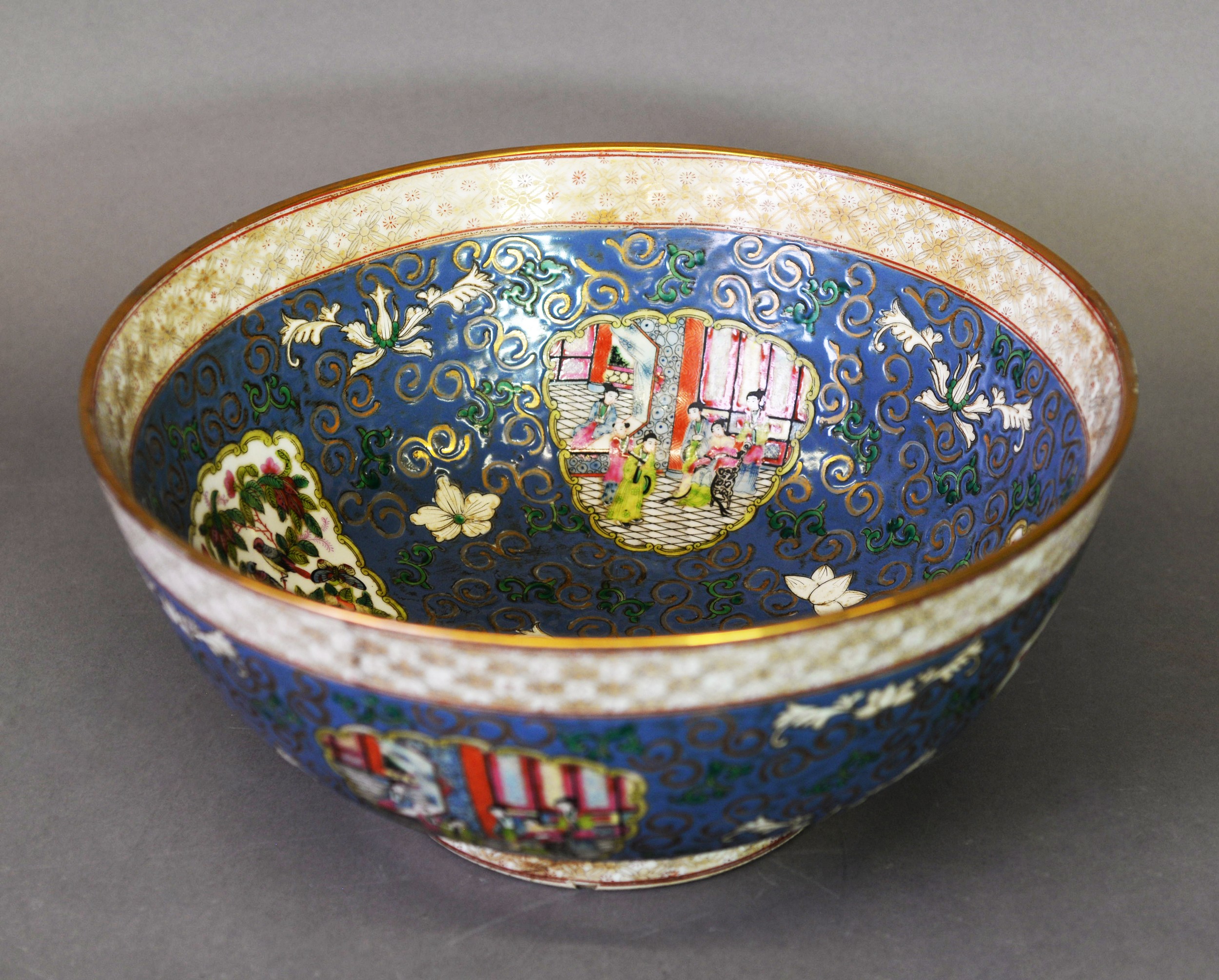 A large 20th Century Chinese canton famille rose porcelain bowl, enamelled in reserves on
