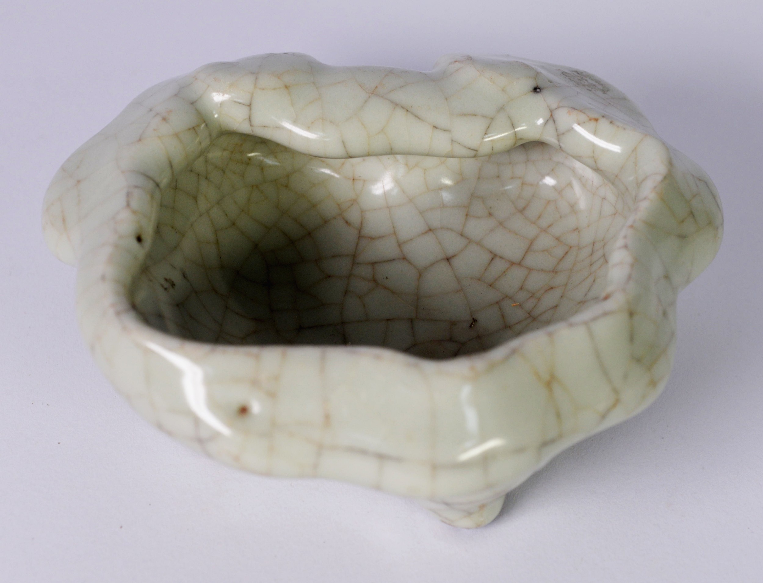 CHINESE PALE CELADON CRACKLE GLAZED PORCELAIN BOWL OF IRREGULAR FORM, raised on four stud feet, - Image 2 of 3