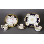A COLLECTION OF COALPORT TEA AND DINNER WARES, decorated with rose bloom reserves to a royal blue