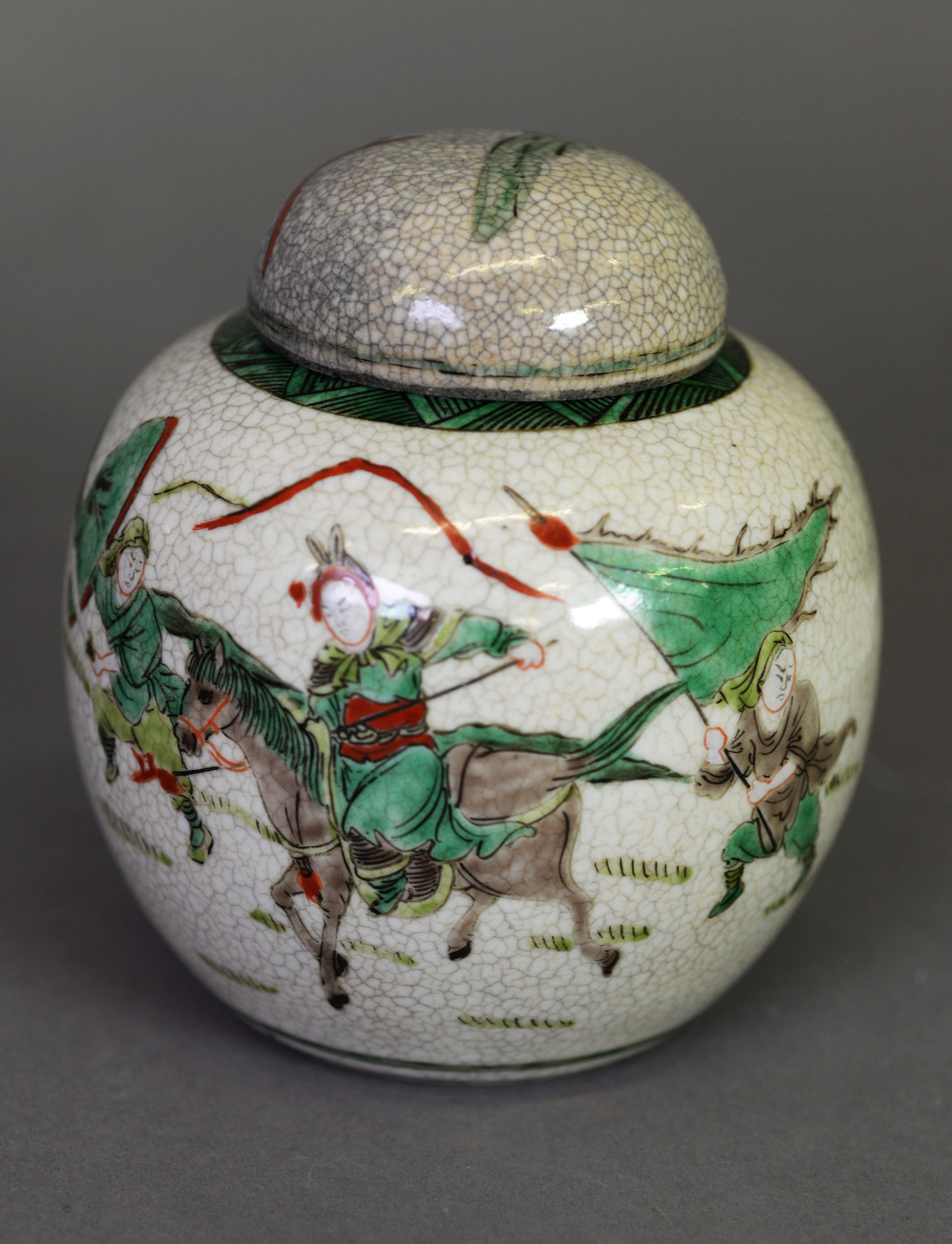 Oriental crackle glazed pottery ginger jar and cover, enamelled autour with warriors, 5” (12.5 cm)