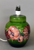 Modern Moorcroft Pottery ovular table lamp, with tube lined red flowers on green ground, 8 ½” (21.