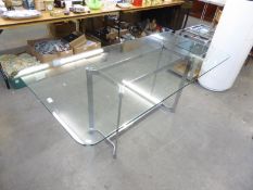 A DINING TABLE WITH OBLONG PLATE GLASS TOP, ON FOUR BRIGHT METAL FLAT LEGS AND H STRETCHERS, 5’10” X