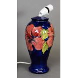 Moorcroft pottery tall ovular vase table lamp, with large red flowers on a royal blue ground, 11” (