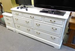 A WHITE FINISH CHEST OF SEVEN DRAWERS AND MATCHING BEDSIDE CHEST