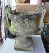 A RECONSTITUTED STONE GARDEN URN AND A TWO HANDLED GARDEN URN (2)