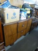 A MID-CENTURY WALNUT COCKTAIL SIDEBOARD WITH SERPENTINE FRONT