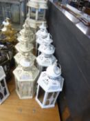 FIVE WHITE PAINTED CANDLE LANTERNS, LACKING GLASS PLUS FIVE CREAM AND GOLD COLOURED  AND GLAZED ON