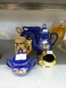 ITALIAN BLUE AND GILT TWO HANDLE POTTERY VASE; A SIMILAR TEAPOT, SUCRIER AND COVER; POTTERY
