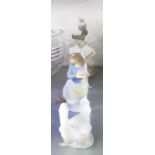 A NAO FIGURE OF A YOUNG GIRL HOLDING HER DRESS, A NAO FIGURE OF A GIRL WITH A PUPPY, ANOTHER OF A