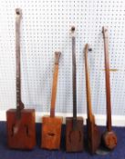 FOUR SINGLE STRING ‘CIGAR BOX’ GUITARS OR JAPANESE FIDDLES, 37” (94cm) long and smaller, together