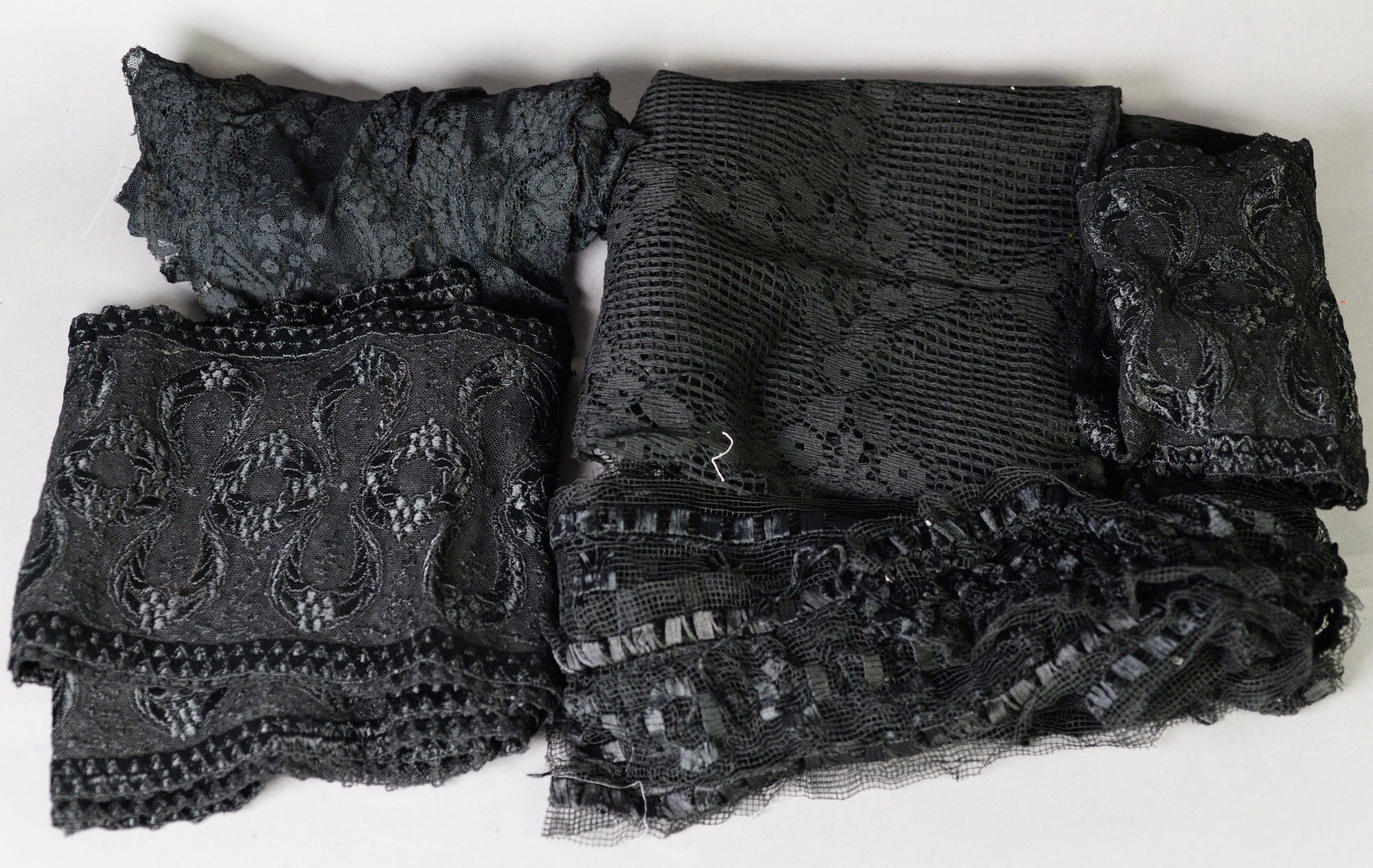 BLACK AND FLORAL PATTERN LACE SHAWL of long triangular form; a QUANTITY OF BLACK LACE, one item of