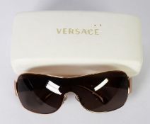 PAIR OF VERSACE-ITALY SUNGLASSES MODEL No. 2078, having gilt framed dark grey lenses, with simulated