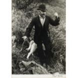 TWO VINTAGE BLACK AND WHITE PHOTOGRAPHIC PRINTS, ONE of a man with dogs amongst ferns, signed BEN
