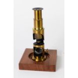 SMALL CULPEPER TYPE MONOCULAR LACQUERED BRASS MICROSCOPE, 6in (15.3cm) high, now on a stained wood