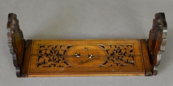 SORRENTO WARE OLIVE WOOD EXTENDING BOOK RACK, the fret pierced ends and base painted wiht swallos in