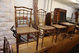 A SET OF THREE BAMBOO PATTERN BEDROOM SINGLE CHAIRS, WITH SPINDLE BACKS, CANE PANEL SEATS (3)