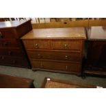 AN OAK CHEST OF TWO SHORT AND TWO LONG DRAWERS, ON BUN FEET, 3’6” WIDE