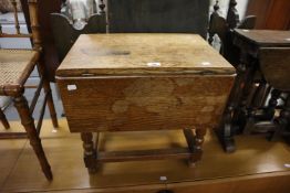 AN OAK COFFEE TABLE/STOOL WITH SINGLE FALL LEAF, ON BALUSTER LEGS WITH THREE STRETCHER RAILS