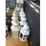 FIVE WHITE PAINTED CANDLE LANTERNS, LACKING GLASS PLUS FIVE CREAM AND GOLD COLOURED  AND GLAZED ON