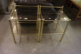 A PAIR OF GILT TUBULAR BRASS AND PLATE GLASS TWO-TIER BEDSIDE TABLES