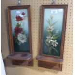 A PAIR OF VICTORIAN CARVED WOOD WALL SHELVES, TALL AND NARROW, THE MIRROR BACKS PAINTED WITH FLOWERS