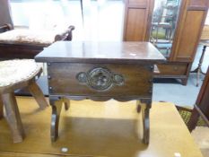 A CARVED OAK OBLONG BOX STOOL WITH HINGED LID ON TRESTLE END SUPPORTS