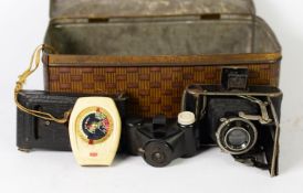 TIN CONTAINING TWO VINTAGE VEST POCKET BELLOWS FOLDING ROLL FILM CAMERAS, Kodak model B and German