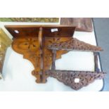 A VINE CARVED AND PIERCED TWO TIER MURAL SPOON RACK AND A PLAIN SMALL WALL RACK (2)