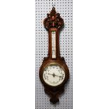 EARLY TWENTIETH CENTURY CARVED OAK ANEROID BAROMETER, the 8 ½” dial housed in a banjo shaped case